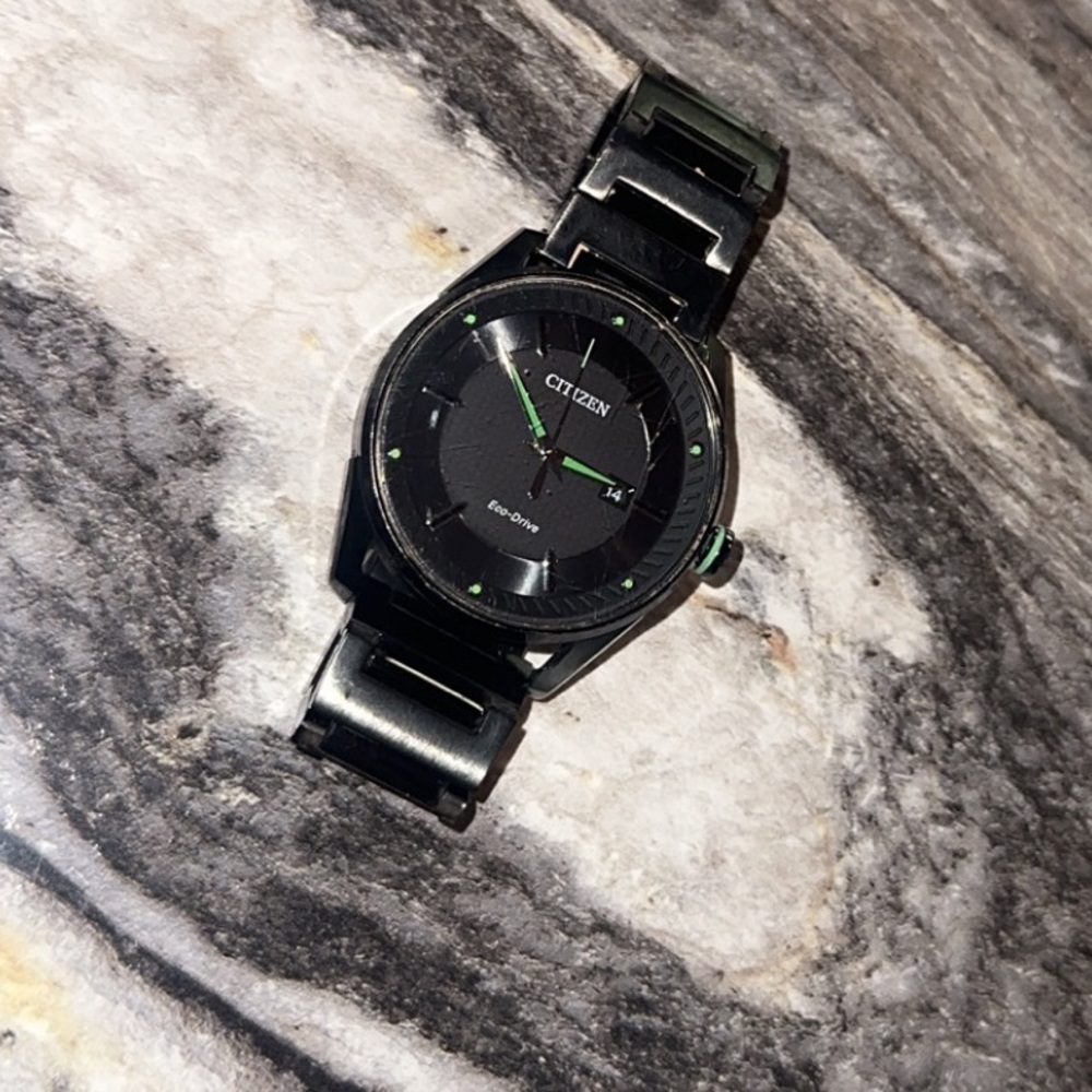 Citizen Eco-Drive watch with green detailing.